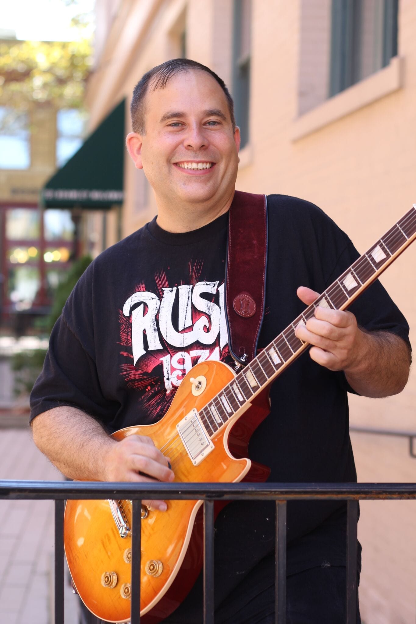 A man holding an electric guitar in his hands.